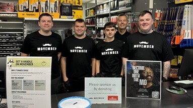 The South Shields depot team wearing t-shirts and standing in their depot to promote Movember.