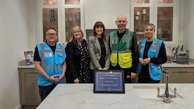 Five Howdens staff members in a diversity and inclusion working group, displaying Menopause Friendly Employer certificate.