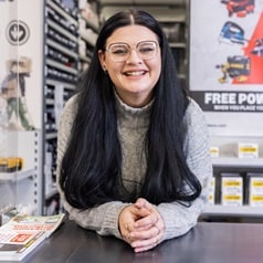 Image of a Business Developer stood behind a trade counter